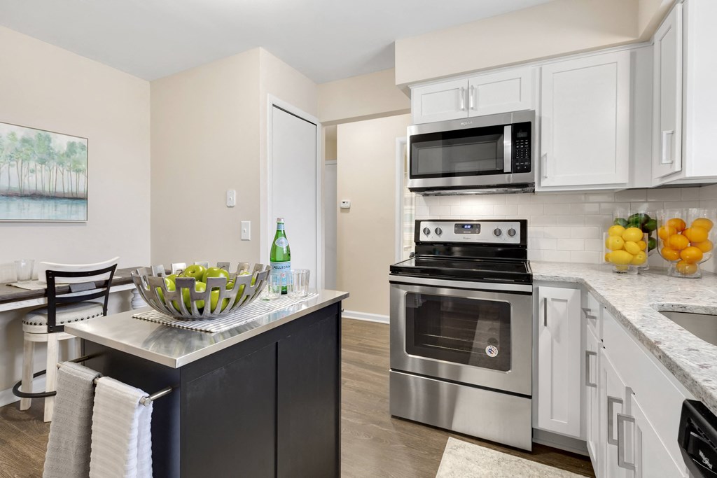 a kitchen with white cabinetry and stainless steel appliances  at Northridge, Rochester Hills