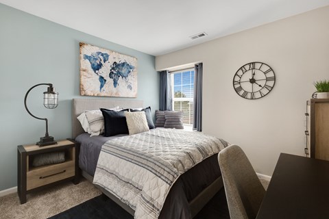 a bedroom with a large bed and a large window  at Northridge, Rochester Hills