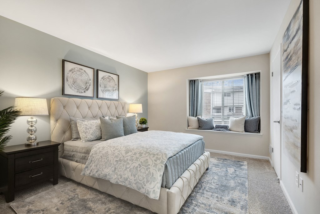 a bedroom with a large bed and a window  at Northridge, Rochester Hills, 48307
