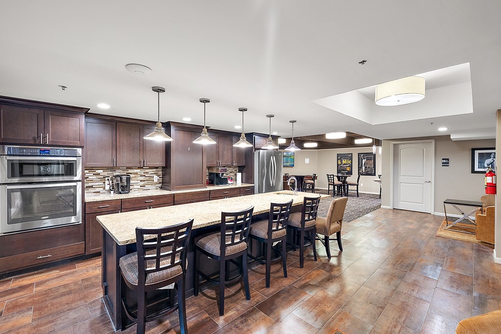 A kitchen with a table and chairs in the middle of the room at MainCentre, Northville