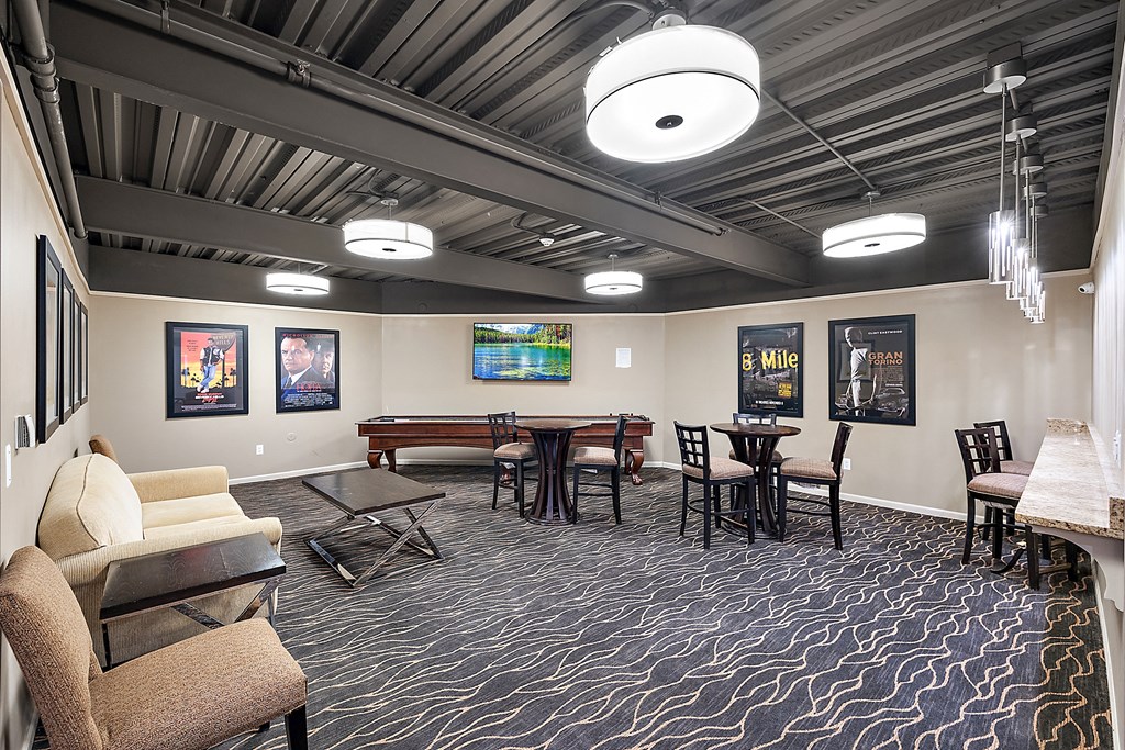 A room with a patterned carpet and a long table with chairs at MainCentre, Northville