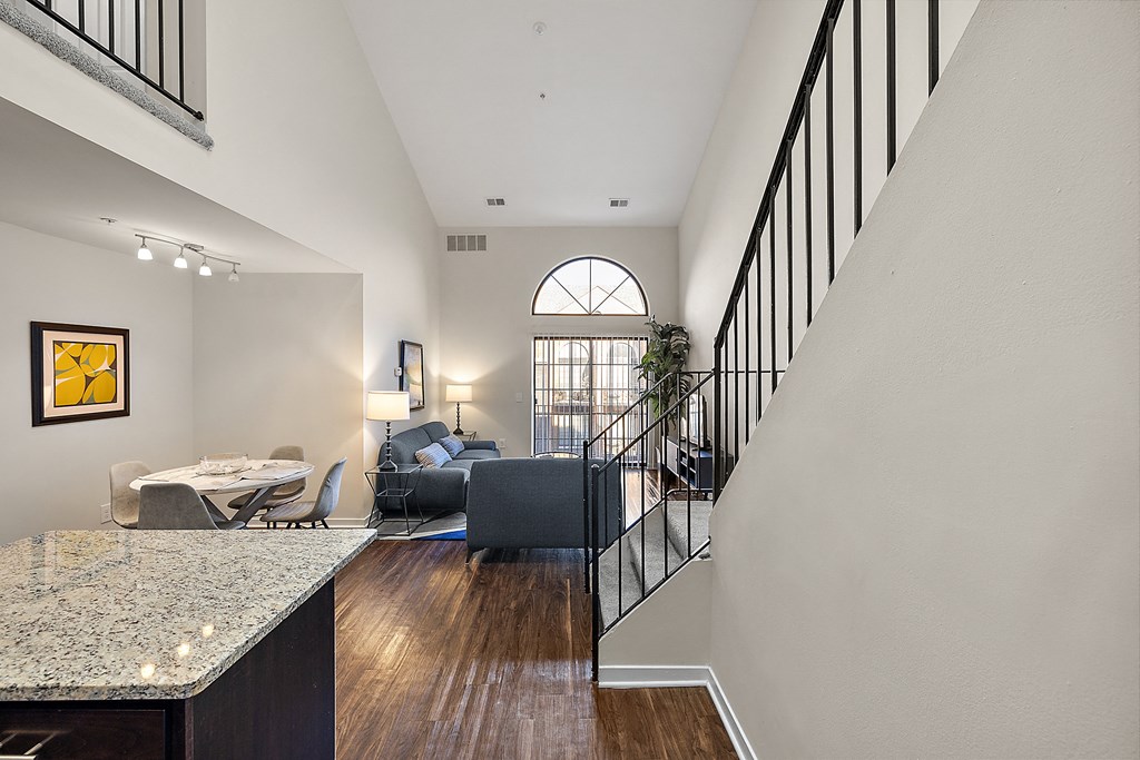 A living room with a couch, a chair, a dining table and a painting on the wall at MainCentre, Northville