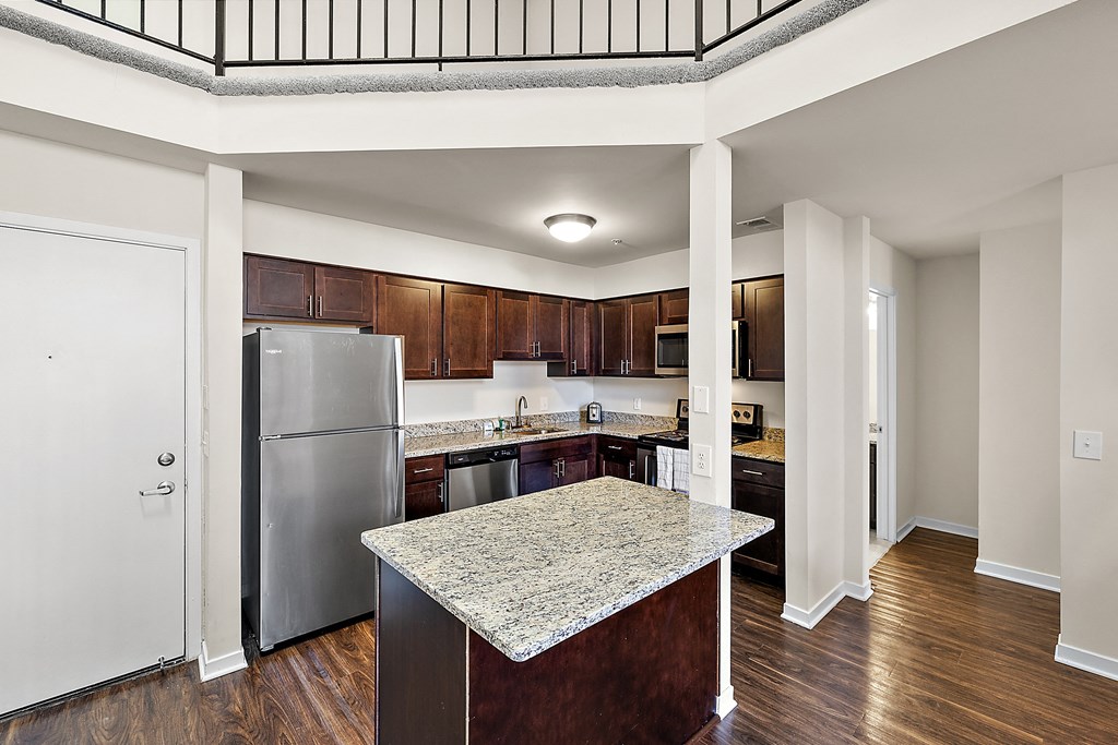 A kitchen with a marble island in the middle of the room at MainCentre, Northville