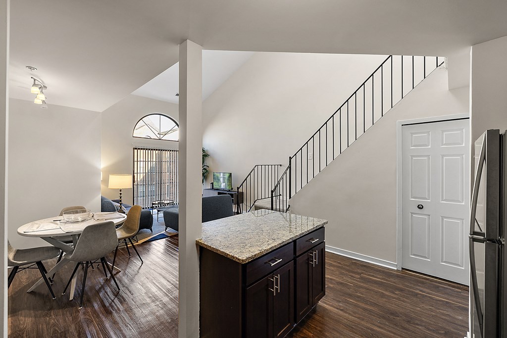 A kitchen with a table and chairs is visible from the dining room at MainCentre, Northville