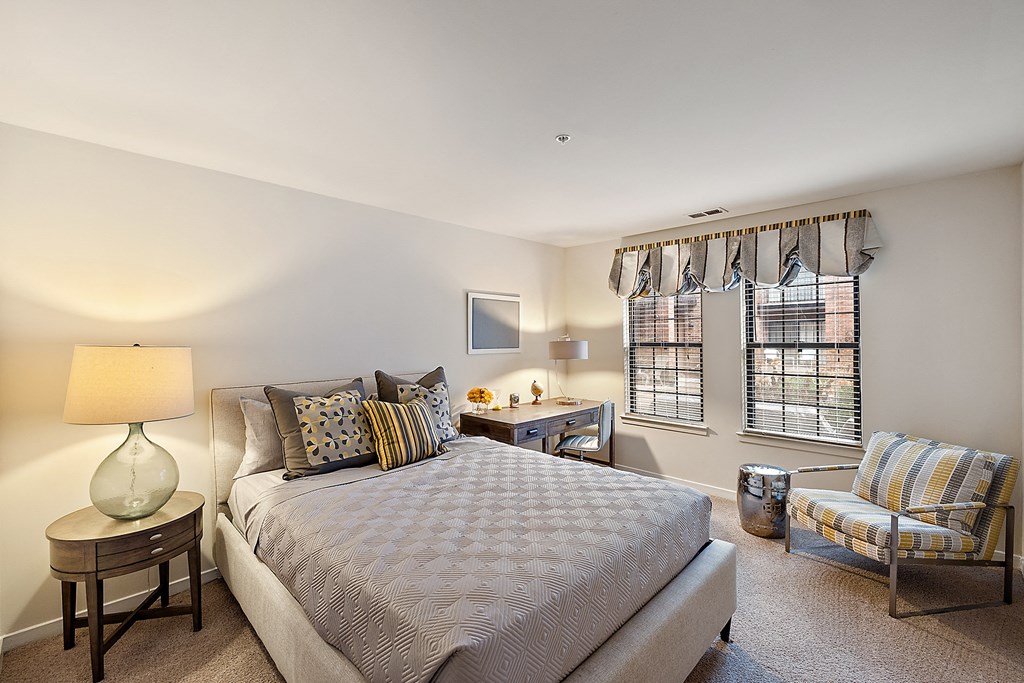 A bedroom with a large bed and a chair at MainCentre, Northville