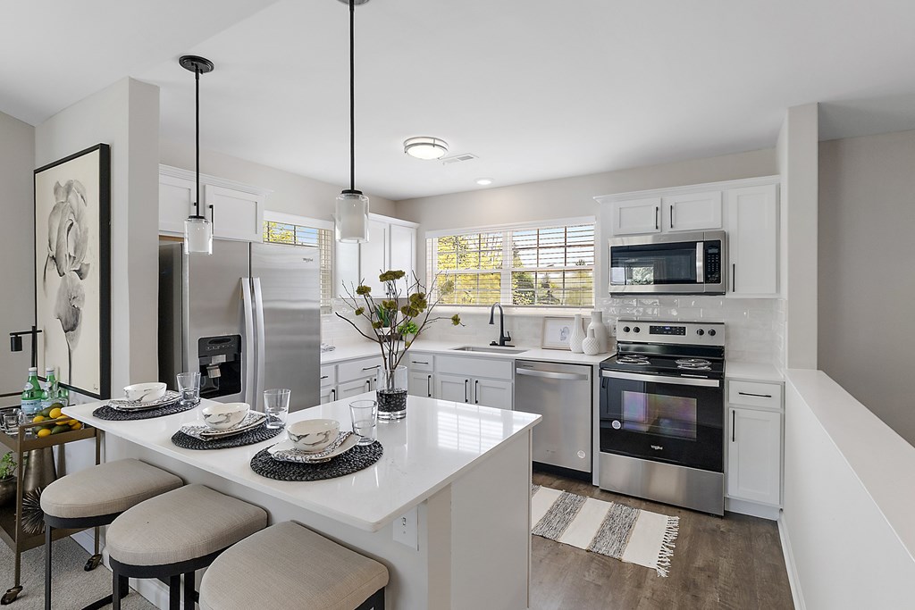 A modern kitchen with a breakfast table set for two.