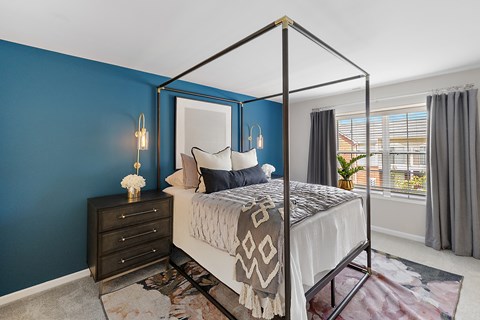 A bedroom with a four poster bed and a dresser at Briarcliff Village, Michigan, 48390