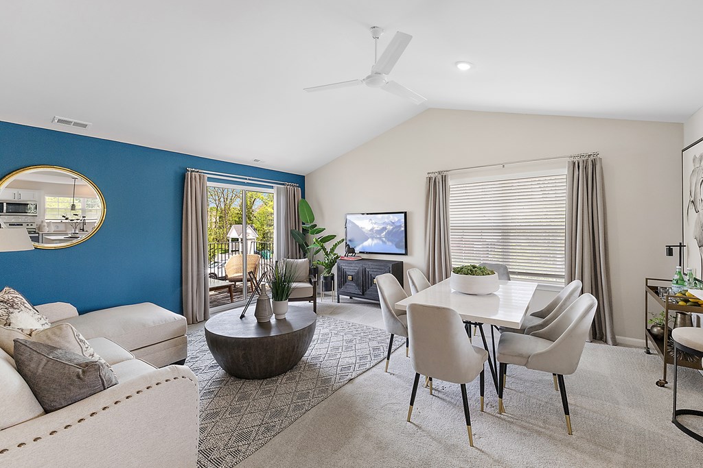 A living room with a blue wall and a television.
