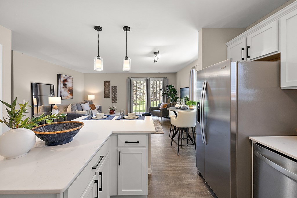 A modern kitchen with a large island and stainless steel appliances.