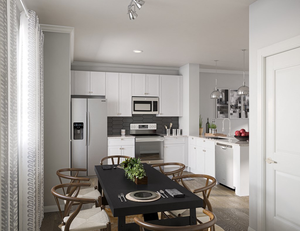 Townhome kitchen with stainless steel appliances, dining area, and granite countertops  at Griffin Weston, Cary