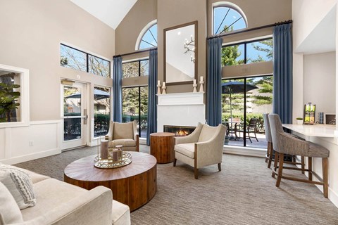 a living room with a couch and chairs and a fireplace