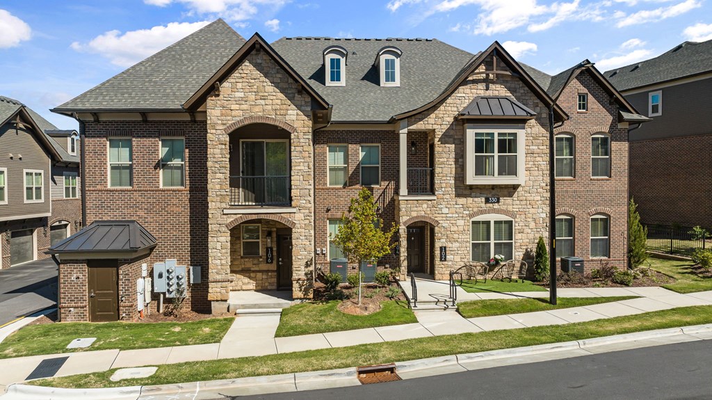 a house on a street with a sidewalk in front of it  at Griffin Weston, Cary, North Carolina