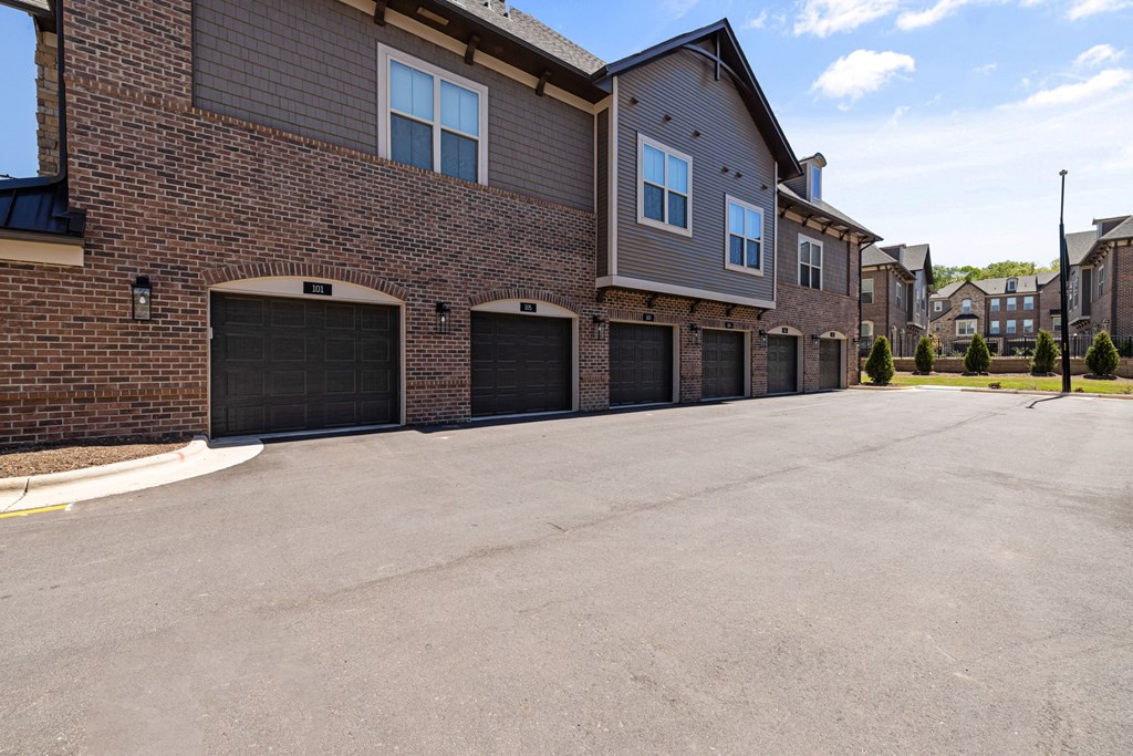 a driveway with a two car garage in front of a brick building  at Griffin Weston, Cary, North Carolina