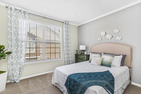 A bedroom with a large bed and a window with curtains at Park West, Canton, 48187