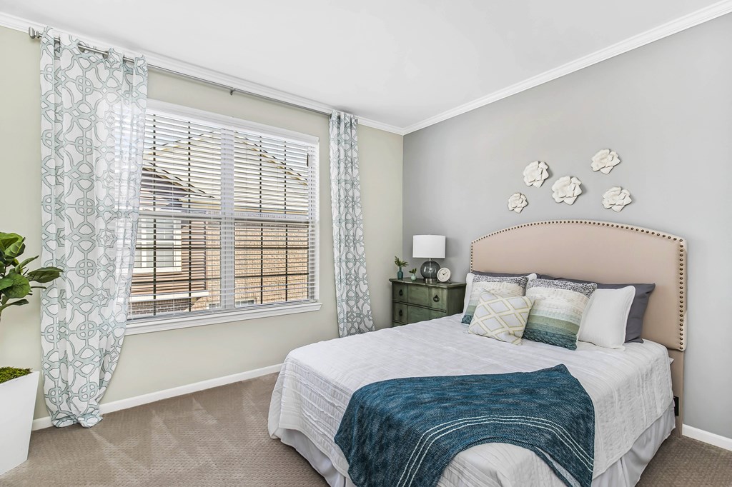 A bedroom with a large bed and a window with curtains at Park West, Canton, 48187