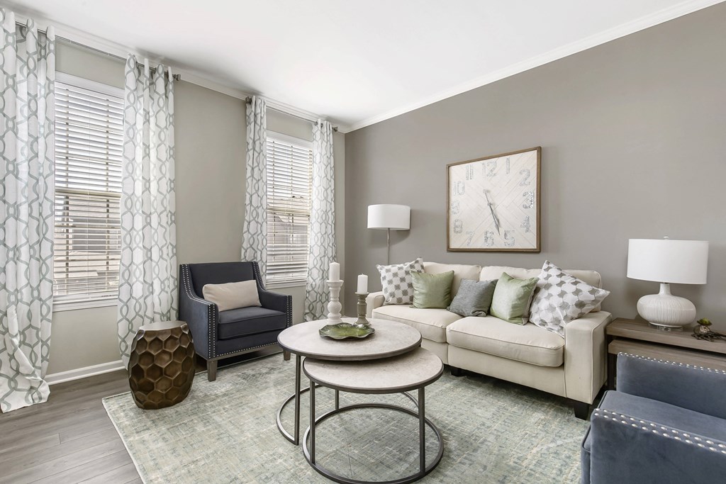 A living room with a sofa, armchair, and coffee table at Park West, Canton, 48187