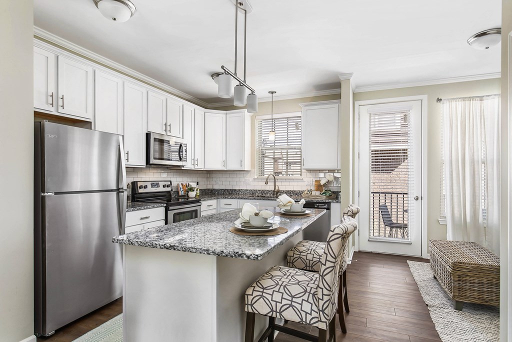 A kitchen with a refrigerator, microwave, oven, and sink at Park West, Canton, 48187