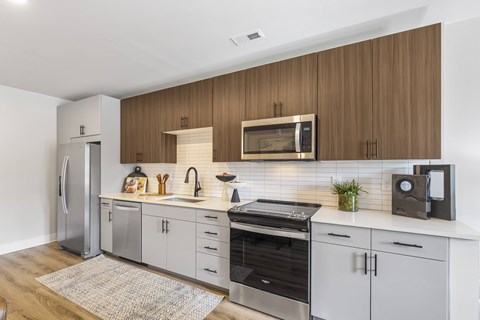 A modern kitchen with wooden cabinets and stainless steel appliances.