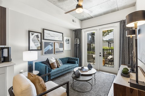 A living room with a blue couch and a coffee table.
