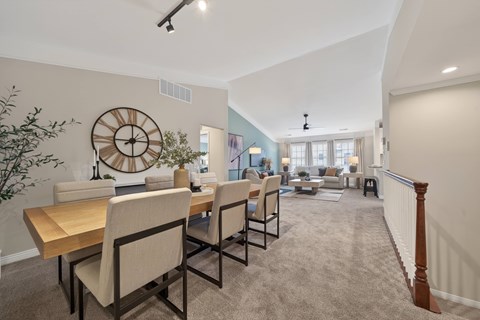Dining room with vaulted ceiling and living area at Brandywine Apartments, Michigan