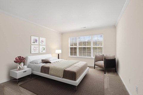 Bedroom with platform bed and window seating at Brandywine Apartments, West Bloomfield, 48322