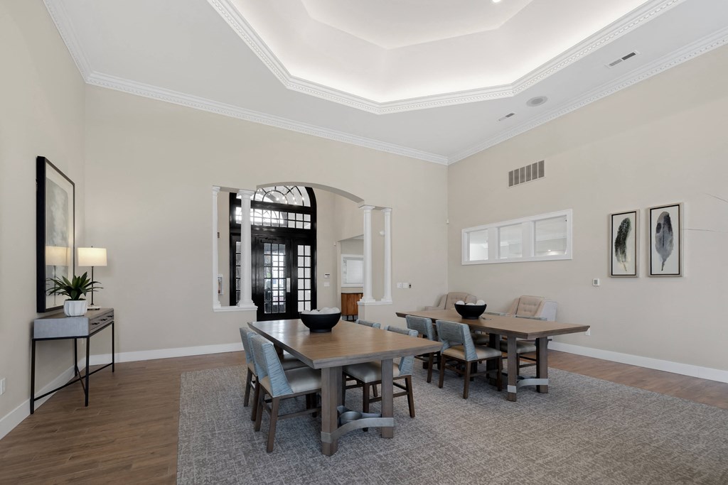 a dining room with a wooden table and chairs at Cidermill Village Apartments in Rochester Hills, MI 