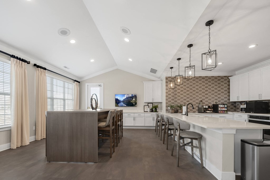 A modern kitchen with a wooden island and stainless steel appliances at Cidermill Village Apartments in Rochester Hills, MI 