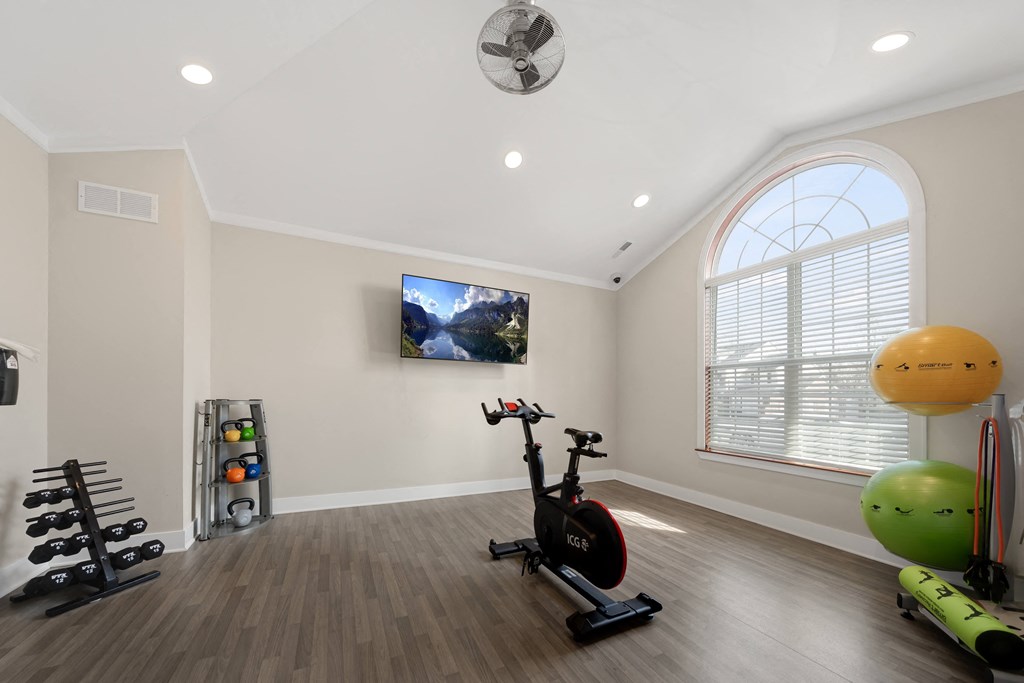 a home gym with exercise equipment and a window at Cidermill Village Apartments in Rochester Hills, MI 