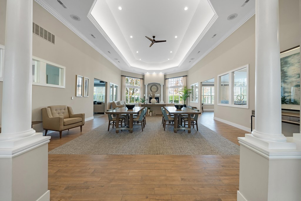 A spacious dining room with a large table and chairs at Cidermill Village Apartments in Rochester Hills, MI 