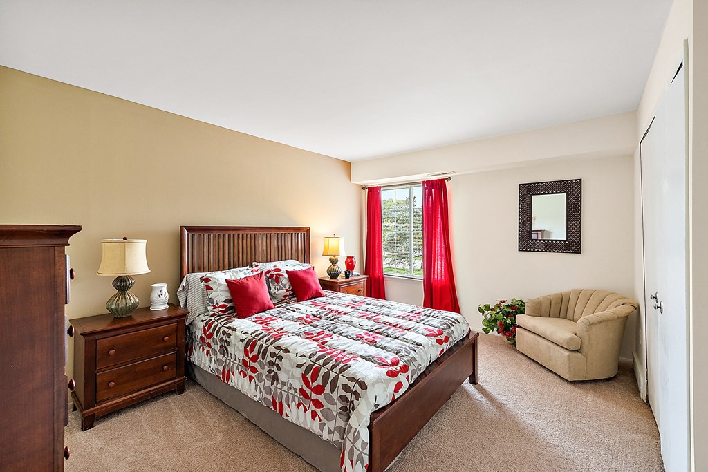 a bedroom with a bed and a chair  at Northridge, Rochester Hills, MI, 48307