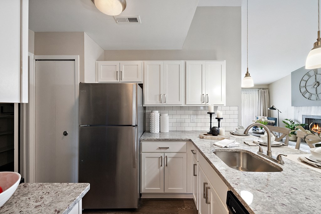 a kitchen with white cabinets and granite countertops  at Northridge, Rochester Hills, MI, 48307