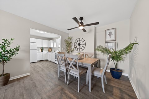 A dining room with a table set for four.