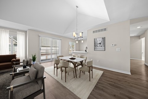 A modern dining room with a glass table and chairs.