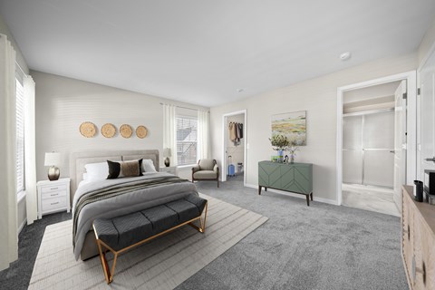 A bedroom with a large bed and a green bench.