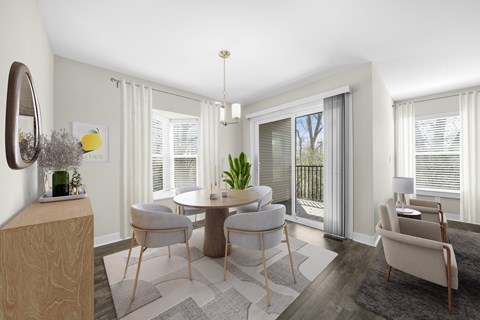 A modern dining room with a round table and chairs at Amberly Apartments, West Bloomfield, 48322