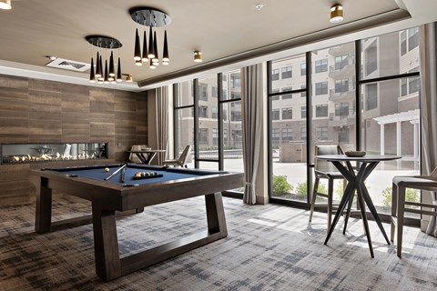 a room with a pool table and a fire place  at The Griffin Royal Oak, Royal Oak, MI