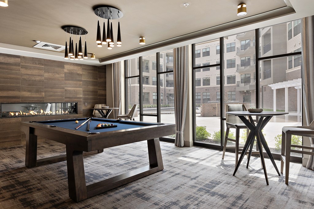 a room with a pool table and a fire place a room with a pool table and a fire place at The Griffin Royal Oak, Royal Oak, MI