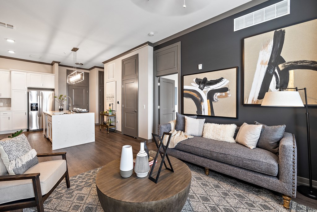 a living room with a gray couch and a wooden coffee table  at The Griffin Royal Oak, Royal Oak, Michigan