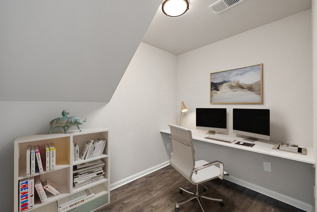 a home office with a desk and two computer monitors at Cidermill Village