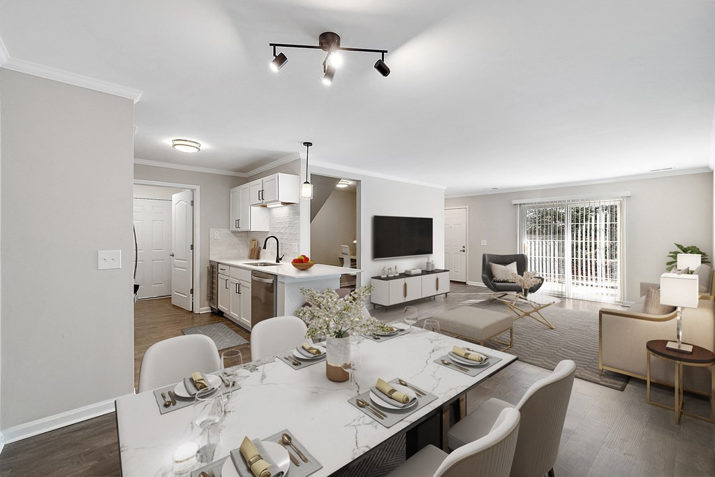 a living room and dining room with a table and chairs at Cidermill Village, Michigan