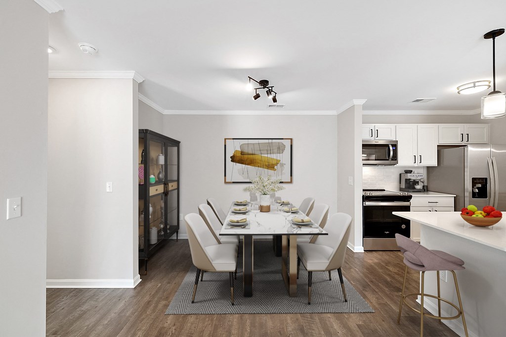 a dining room with a table and chairs and a kitchen at Cidermill Village, 48307