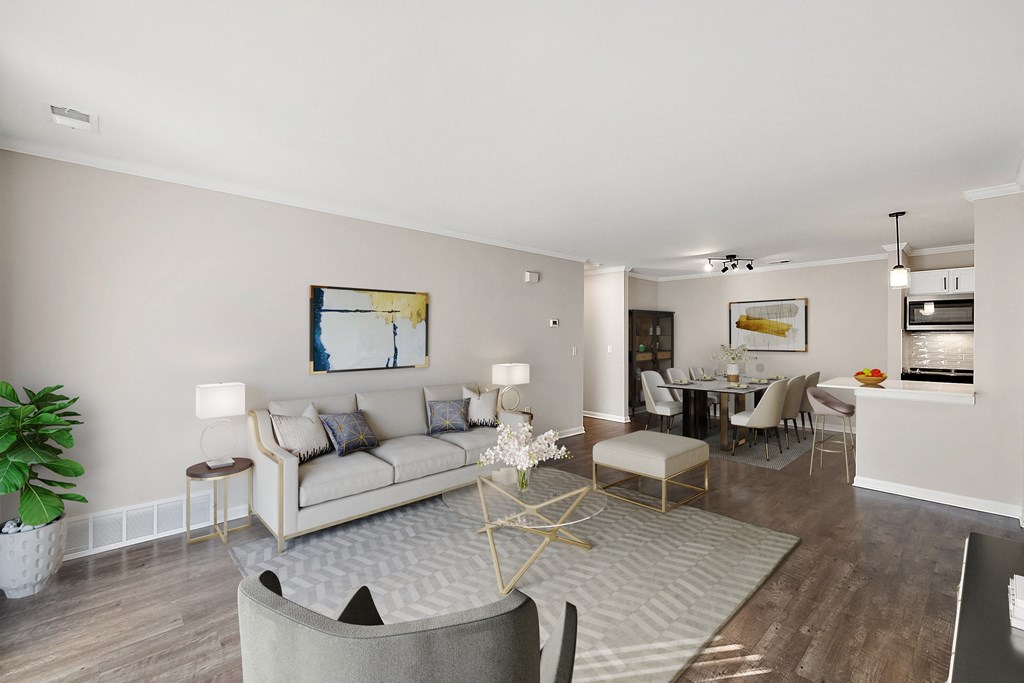 a living room with a couch and a chair and a dining room at Cidermill Village, MI