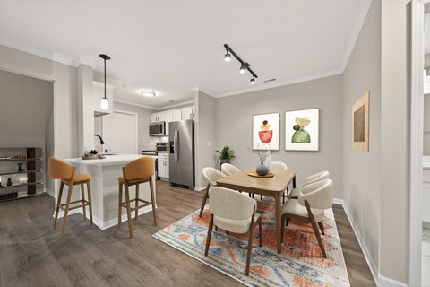 A modern kitchen with a dining table and chairs.