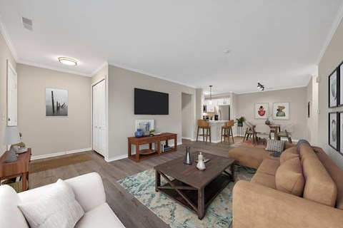 A living room with a white couch and a brown couch.