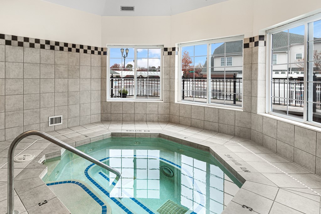 A small indoor pool with a metal railing.