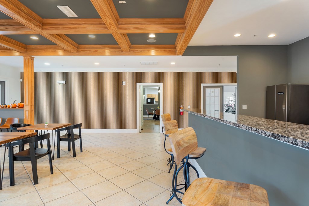 A kitchen with a bar area and a dining table.