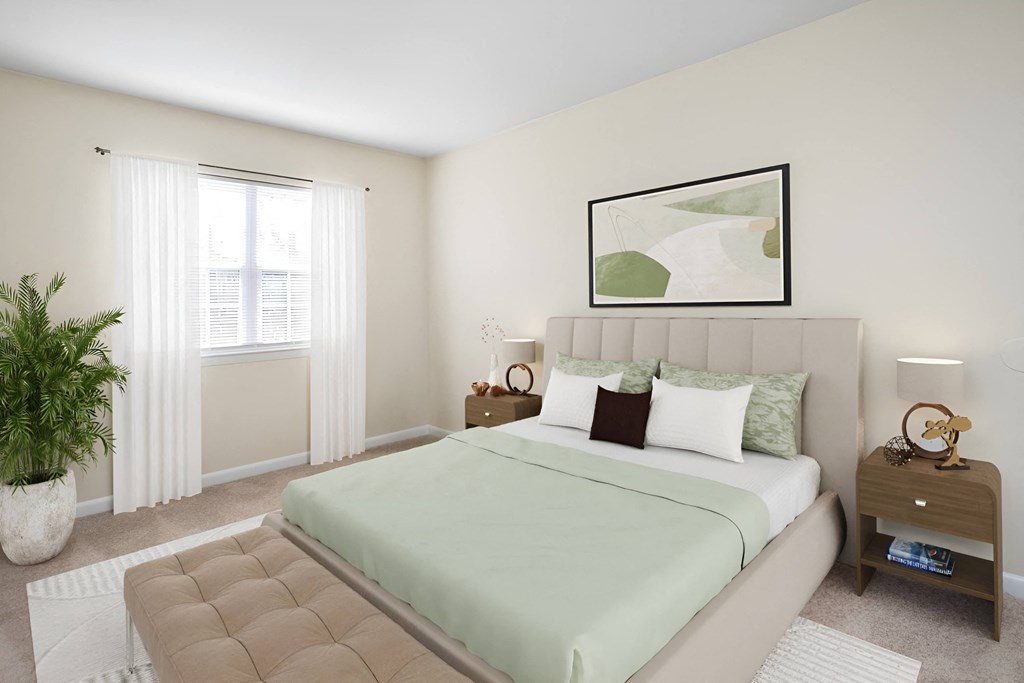a bedroom with a bed and a window at West Pointe Apartments in Burlington, NC