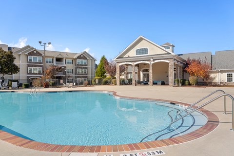 A swimming pool in front of a building with a sign that says 25 FT 09M.