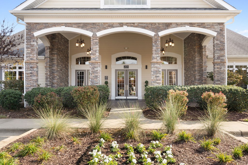 A house with a front yard and a white door.