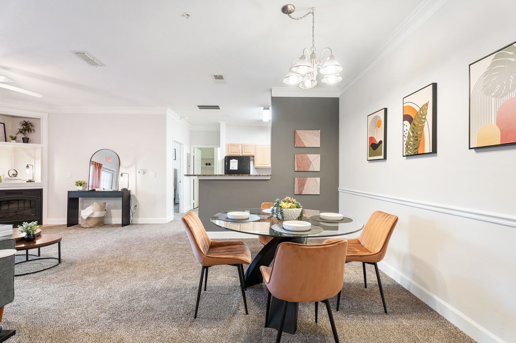 A dining room with a table set for four.